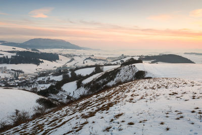 Village in turiec region with view of velka fatra mountain range.