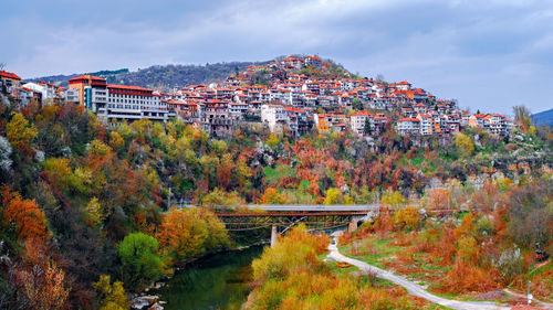 High angle view of autumn trees in city against sky