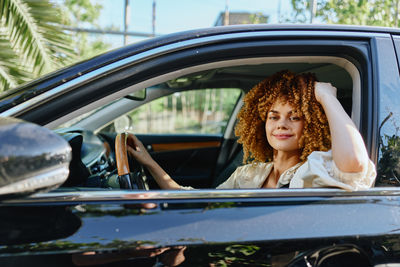 Portrait of young woman in car