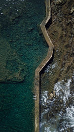 High angle view of rock by sea