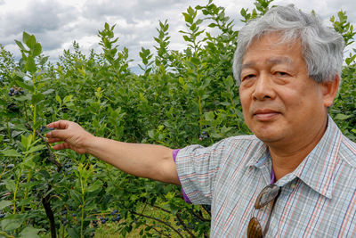 Portrait of man standing in farm