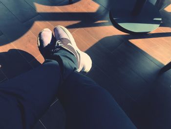 Low section of man sitting on tiled floor