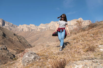 Full length of woman on mountain against sky