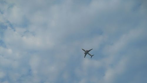 Low angle view of airplane flying in sky