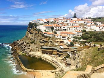 High angle view of townscape by sea