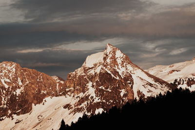 Scenic view of snowcapped mountains against sky during sunset