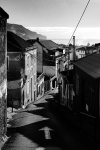 Street amidst buildings in city against sky