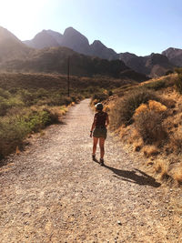 Rear view of woman walking on mountain