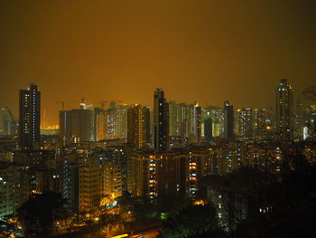 Illuminated cityscape against sky at night