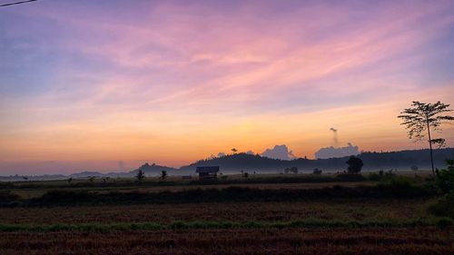 Scenic view of field against sky during sunset