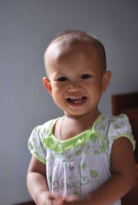 Portrait of smiling girl standing at home