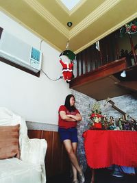 Young woman sitting on sofa at home