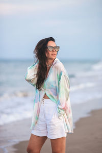 Young woman standing at beach