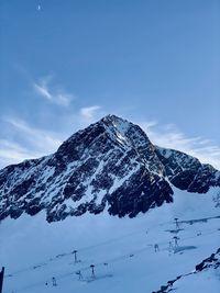 Low angle view of snow covered mountain against sky