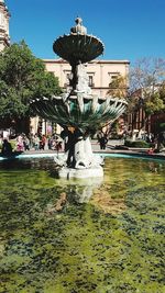 Fountain in park against sky