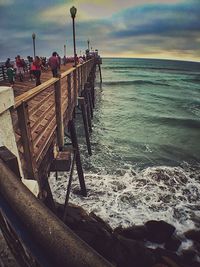 Pier on sea at sunset