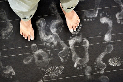 Low section of man with footprints on floor