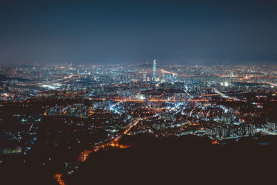 High angle view of city lit up at night