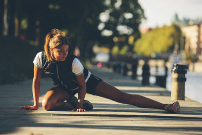 Young woman stretching, uppsala, sweden