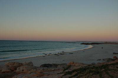 Scenic view of sea against clear sky at sunset