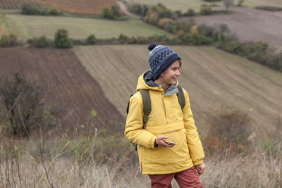 Full length of girl standing on field