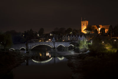 Bridge over river at night