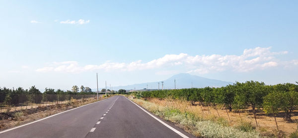 Road passing through landscape against sky