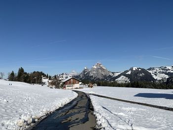 Snow covered mountain against blue sky