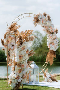 Wedding ceremony area with a round arch of dried flowers