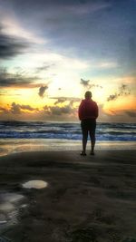 Rear view of man standing on beach