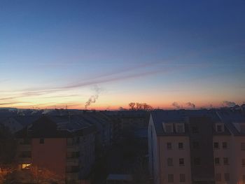 Residential district against sky during sunset