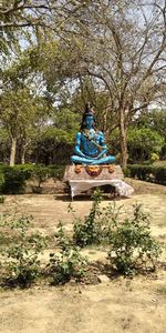 Statue of buddha against trees