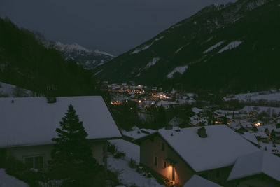 High angle view of townscape by mountains during winter