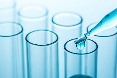 Close-up of medical samples in containers against white background