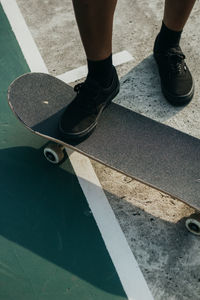 Low section of man standing on road