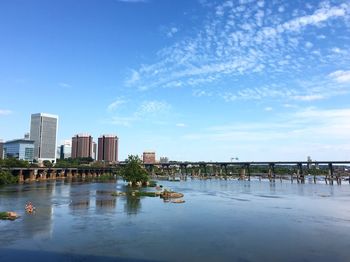 Bridge over river with city in background