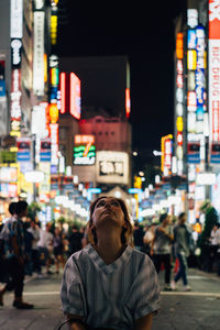 Woman in city at night