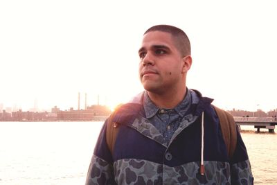 Portrait of young man against clear sky