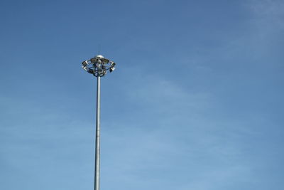 Low angle view of floodlight against blue sky