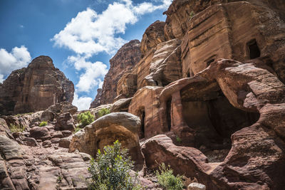 Low angle view of rocks on mountain against sky