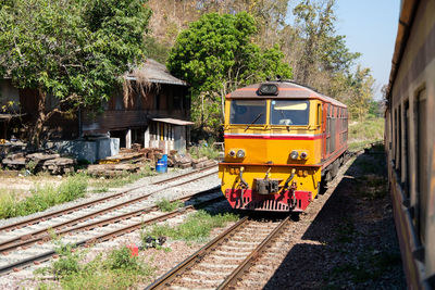 The diesel electric locomotive is parked at a small train station located on the top of the mountain