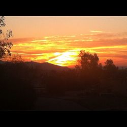 Scenic view of landscape against sky at sunset