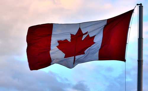 Low angle view of flag on pole against sky