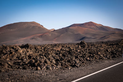 Scenic view of arid landscape against clear sky