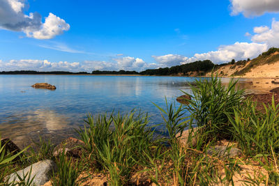 Scenic view of lake against blue sky