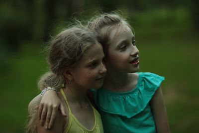 Close-up of sisters wearing make-up outdoors