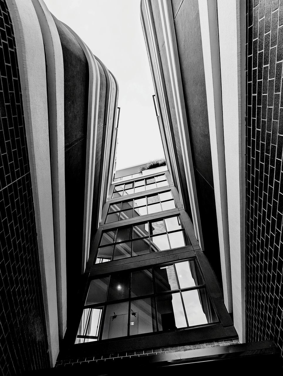 black, architecture, built structure, black and white, monochrome, monochrome photography, building exterior, building, white, low angle view, skyscraper, no people, window, city, sky, day, office building exterior, glass, outdoors, office, staircase, line