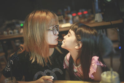 Innocent girl with mother at restaurant