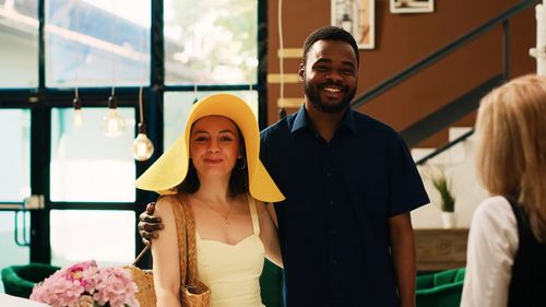 Portrait of smiling young woman standing in city