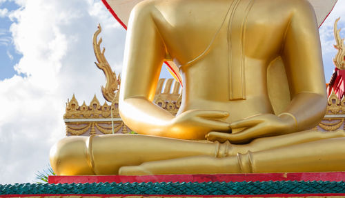 Low angle view of statue in temple against sky